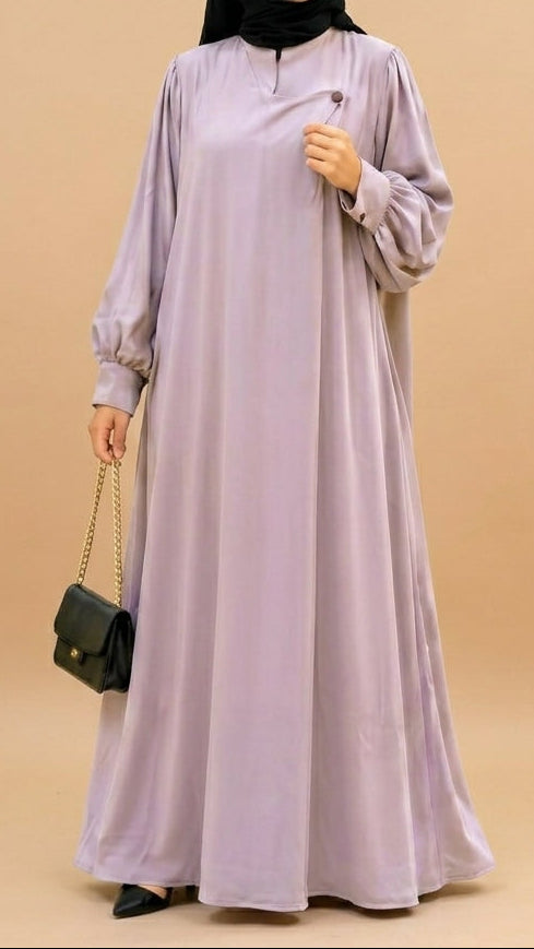 Person wearing a long light purple dress and black hijab on a beige background
